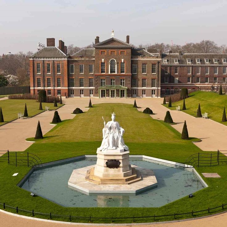 The exterior of Kensington Palace, a prestigious luxury wedding venue in London, featuring beautifully manicured gardens and a grand statue of Queen Victoria in the foreground.